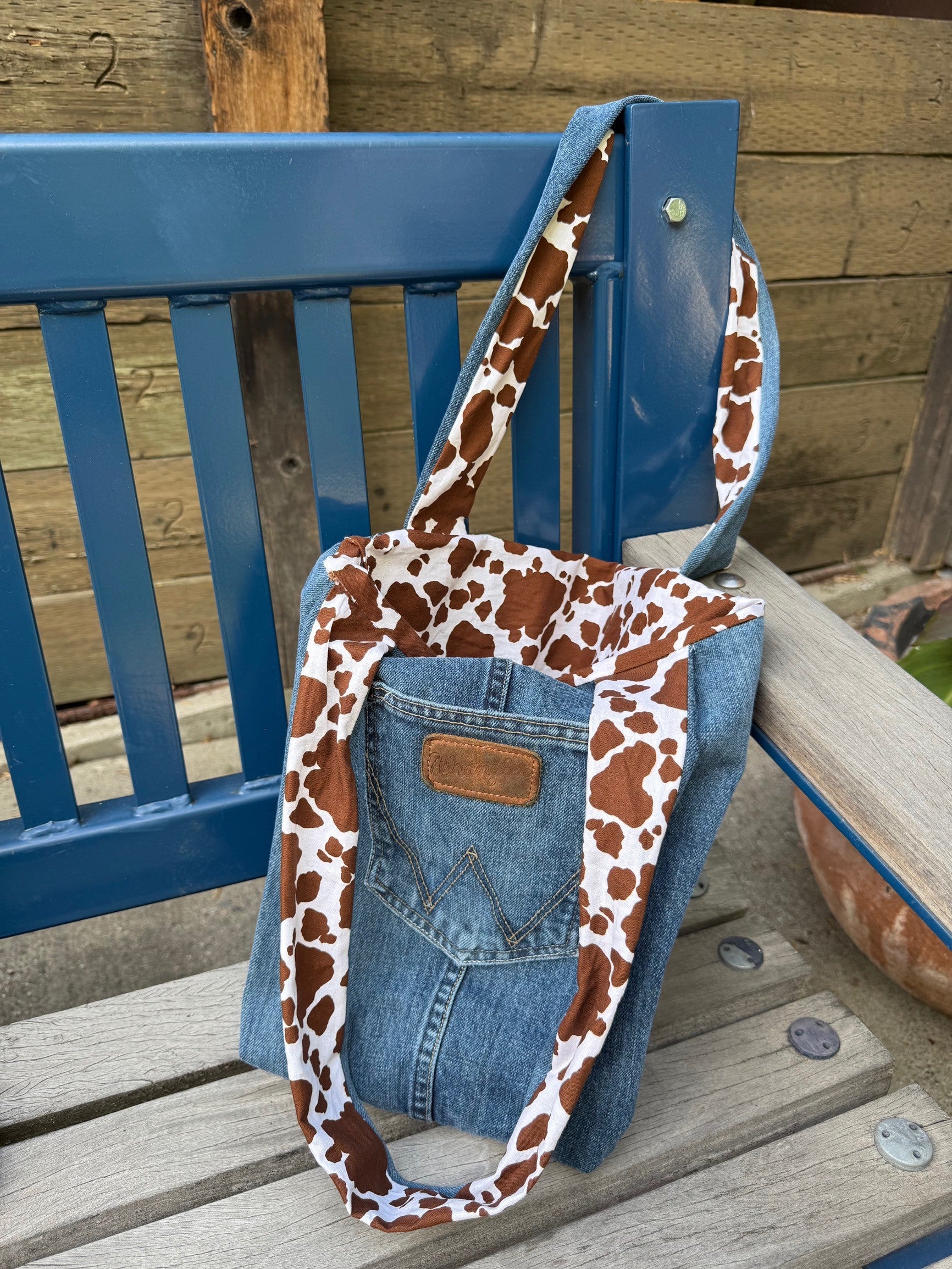 Wrangler denim tote bag with cow print material lining and strap